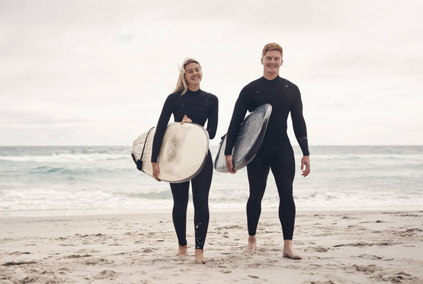 Weve experienced the greatest highs and toughest lows by surfing together. a young couple out at the beach with their surfboards - 写真・画像