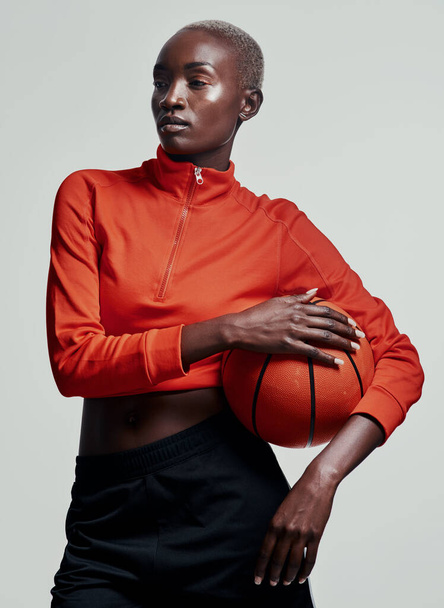 Basketball or nothing at all. Studio shot of an attractive young woman playing basketball against a grey background - Fotoğraf, Görsel