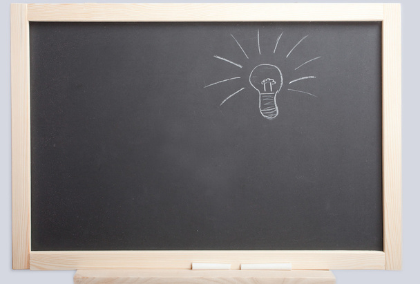 Light bulb on blackboard - Photo, Image