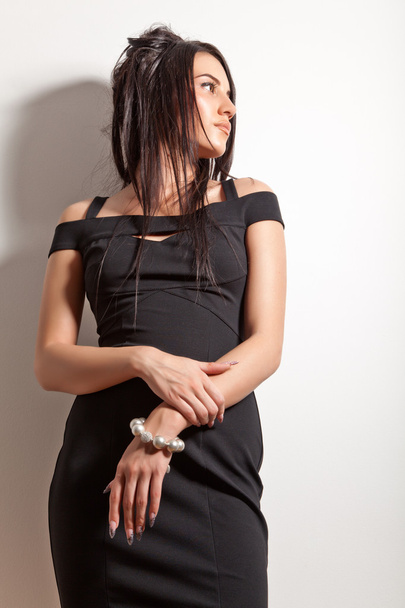 Attractive brunette girl in fashion black dress - Foto, afbeelding