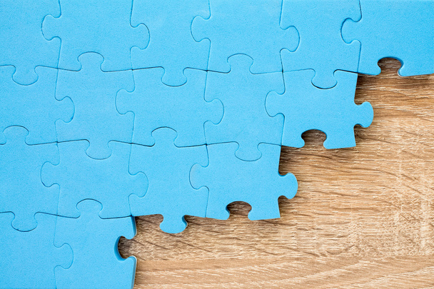 Jigsaw puzzle on wooden background - Фото, зображення