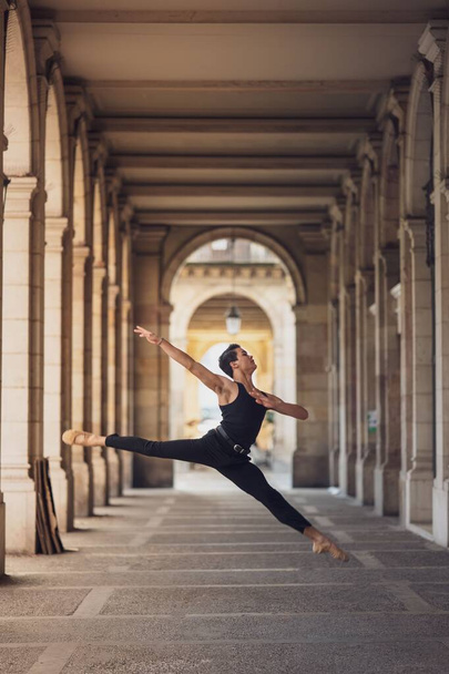 A young man dancing classical ballet in the streets of Barcelona with a beautiful background - Fotoğraf, Görsel