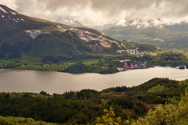 A Norwegian fjord with snowy peaks and a cloudy sky in the background, Karvag, Norway - Valokuva, kuva