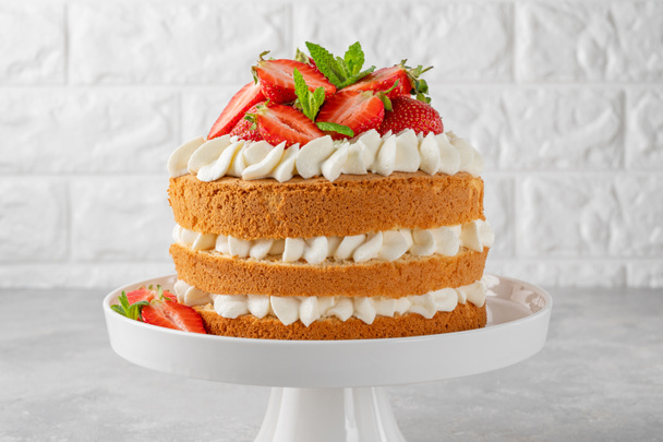 Strawberry cake, vanilla sponge cake with cream cheese and fresh strawberries. Summer cake. Selective focus - Photo, Image