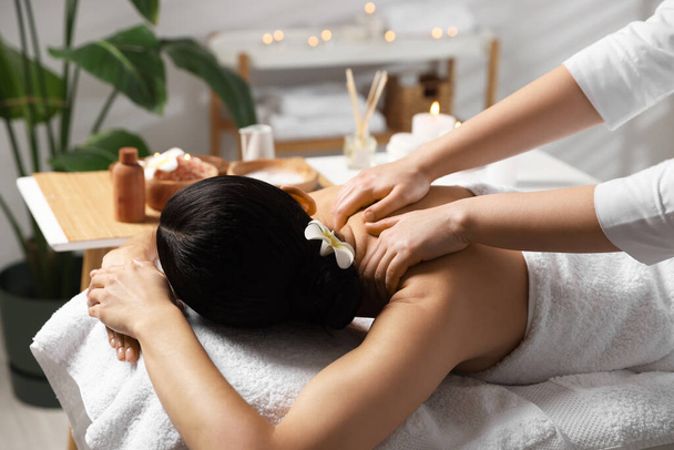 Beautiful woman receiving back massage in beauty salon, closeup - Фото, зображення