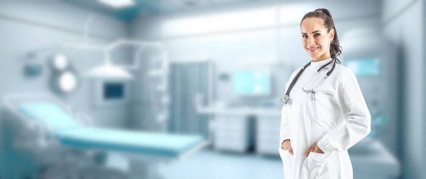Smiling female doctor in a white coat with a stethoscope in the background of a defocused modern ambulance interior - Copy space. - Foto, Imagen