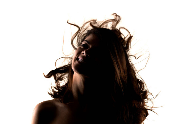 silhouette portrait of a beautiful girl with waving hair - Foto, Imagem