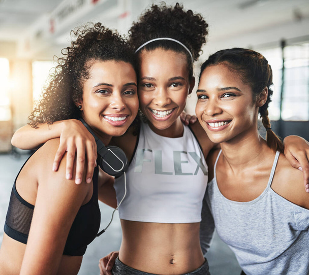 Keep your friends close and keep those spirits lifted. a group of happy young women enjoying their time together at the gym - Фото, изображение