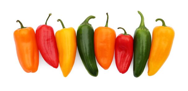 Different hot chili peppers isolated on white, top view - Foto, afbeelding