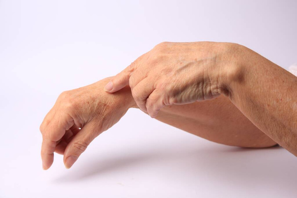 Closeup view of woman's hands with aging skin - Fotó, kép