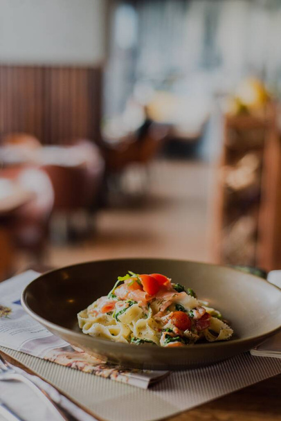 A close-up shot of tagliatelle pasta with cherry sauce in a restaurant - Zdjęcie, obraz