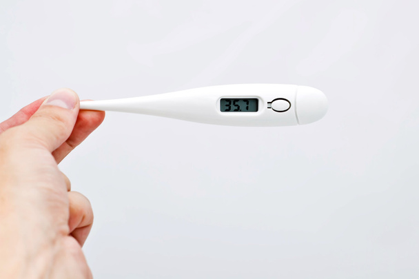 Electronic thermometer in the hand - Photo, Image