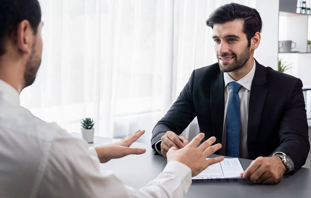 Interviewing job applicant in office with resume paper. Candidate wear suit for formal conversation with interviewer. Recruitment process with question about career and work experience. Fervent - Foto, imagen