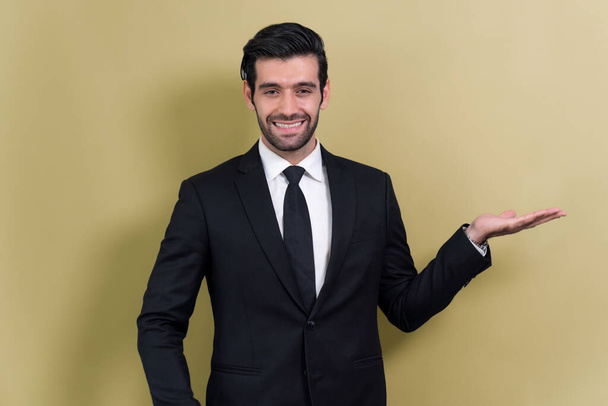 Confident businessman in formal suit making holding hand gesture to indicate promotion or advertising on empty space with excited facial expression and gesture on isolated background. Fervent - Foto, Imagem