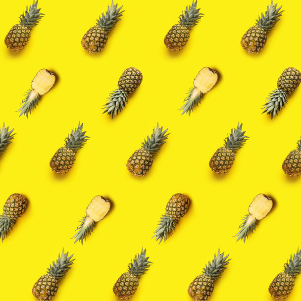 Many ripe pineapples on yellow background. Pattern for design - Фото, изображение