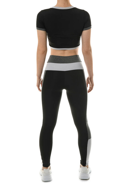 Sporty young woman in leggings on white background, back view - Photo, Image