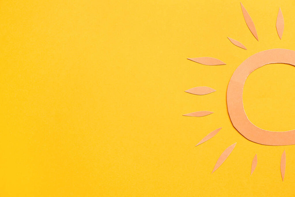 Paper sun on yellow background - Photo, Image