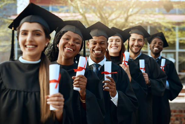 The start of many more successes to come. Portrait of a group of young students holding their diplomas on graduation day - Фото, изображение