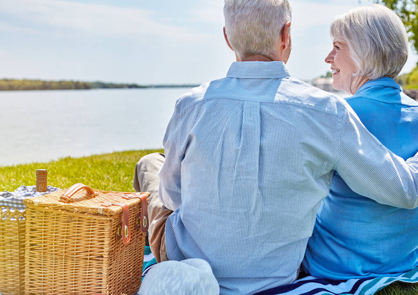 In a world of our own. a happy senior couple having a picnic together outside - Photo, image