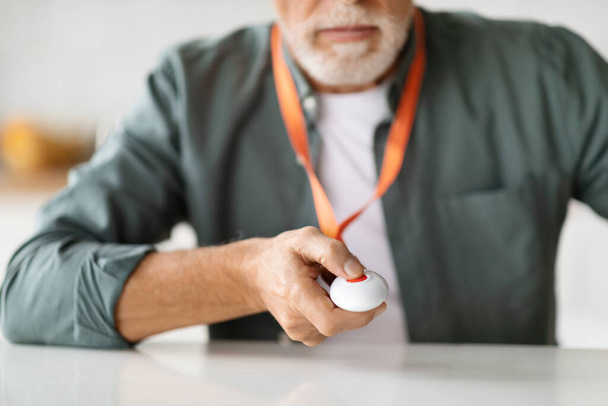 Unrecognizable Senior Man Pressing Emergency Call Button For Quick Help, Closeup Shot Of Elderly Gentleman Giving Sos Alarm Panic Call While Sitting At Desk At Home, Selective Focus - Photo, Image