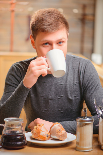 Handsome young man in cafe - 写真・画像