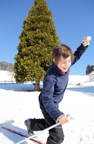 Un jeune garçon tombe avec des skis de fond
 - Photo, image
