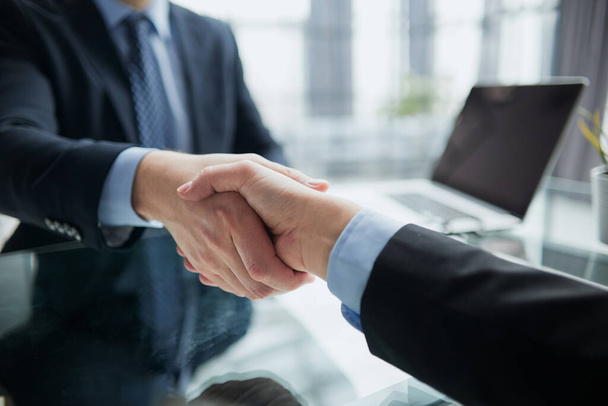 Real estate broker agent Shake hands after customer signing contract document for ownership realty purchase in the office, Business concept and signing contract - Фото, изображение