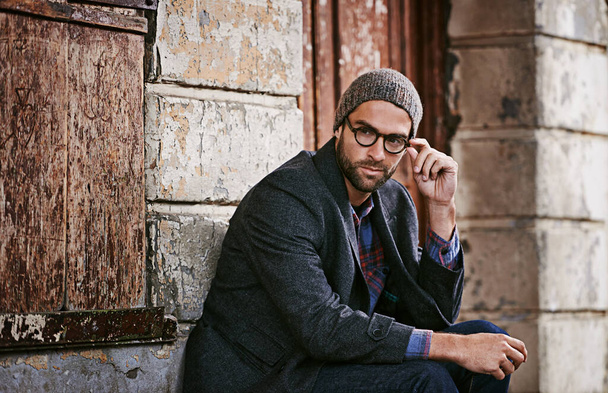 Thinking, fashion and man outdoor, winter and relax with trendy clothes, eyewear and thoughtful. Male person, model or guy with glasses, wonder or ideas with stylish outfit, relax or ponder in a city. - Foto, Imagen