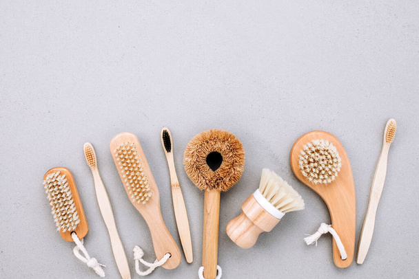 Set of brushes with wooden handles on a gray background, eco friendly products. Flat lay - Foto, Bild