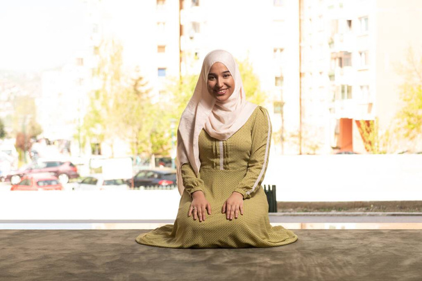 A portrait of a gorgeous humble Muslim woman smiling after a prayer at a mosque - Foto, Bild
