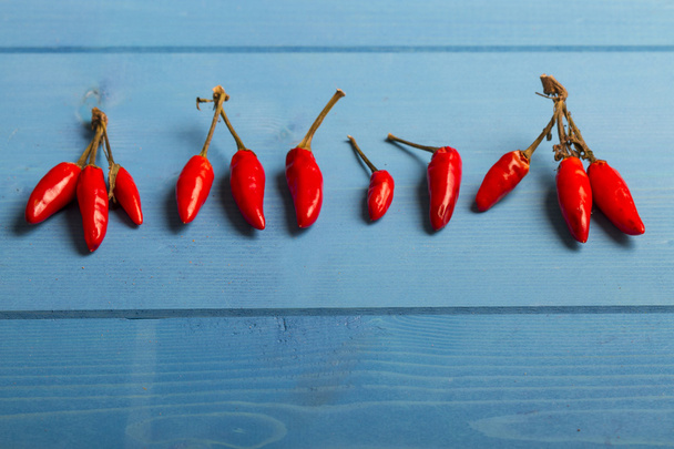 Red Hot Chili Peppers on Blue Wooden Background - Photo, image
