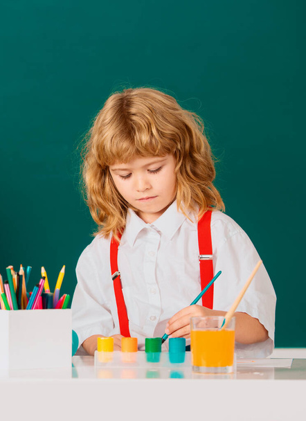 Cute little child studying in classroom at elementary school. Genius child, knowledge day - Valokuva, kuva