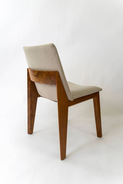 A vertical shot of a wooden chair, with a beige seat cushion isolated on a white background - Valokuva, kuva