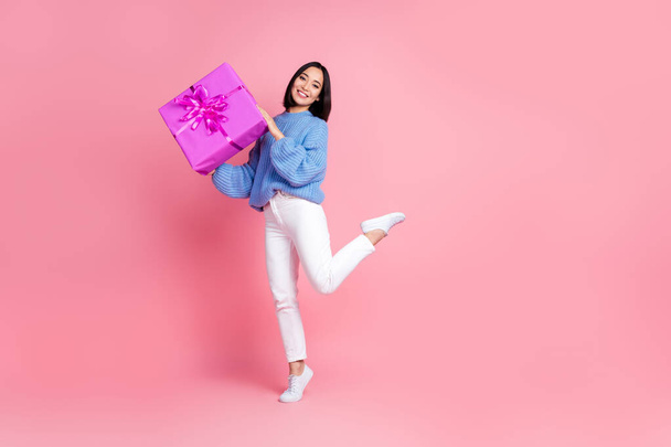Full length photo of cheerful lovely person arms hold desirable giftbox empty space isolated on pink color background. - Zdjęcie, obraz