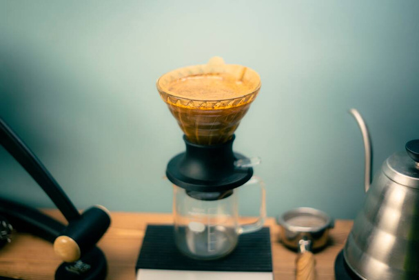 The Hario V60 Immersion Dripper preparing coffee on the blurred background - Valokuva, kuva