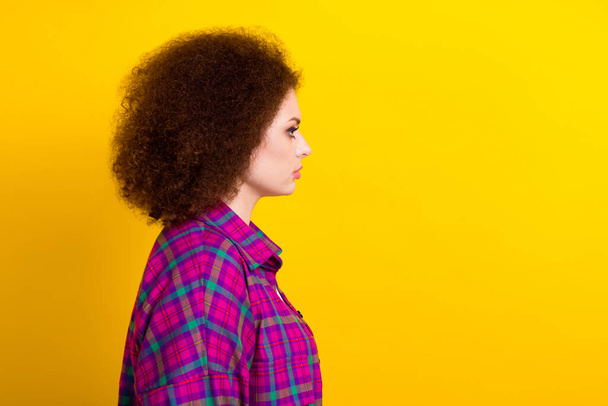 Photo of sweet charming lady wear checkered jacket looking empty space isolated yellow color background. - Zdjęcie, obraz