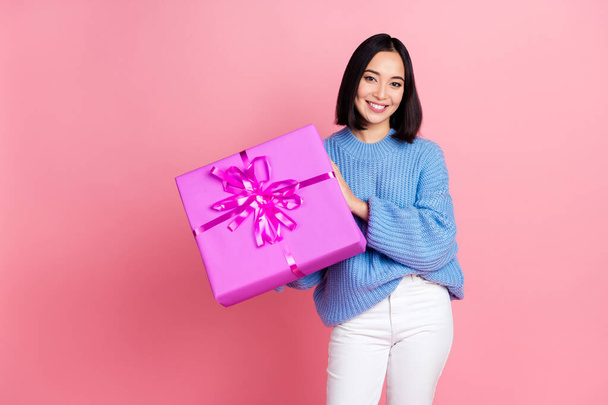 Photo of cheerful gorgeous girl arms hold receive giftbox toothy smile isolated on pink color background. - Fotó, kép