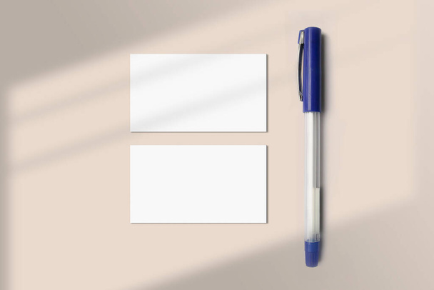 Realistic business card mockup flatlay with a pen. Simple two blank business cards on an elegant light background top view. Two sides of the business card mock up flat lay - Photo, Image