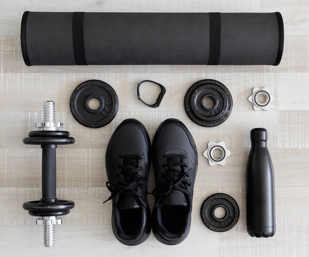 Flatlay of black workout equipment for training at home or gym - Zdjęcie, obraz