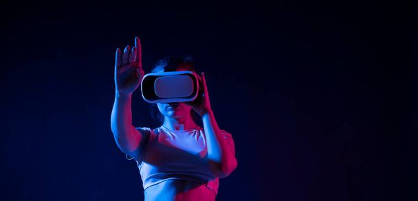 Modern architect, designer woman wearing VR goggles and interacts with metaverse using swipe and stretching gestures. Future technology concept - Fotó, kép