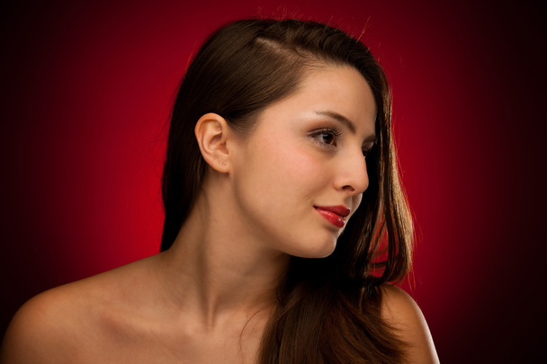 Beauty portrait of a cute caucasian woman over red background - Photo, Image
