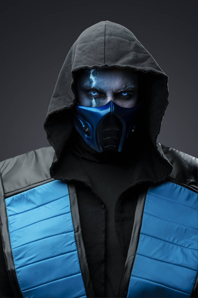 Portrait of Ice ninja with scar dressed in costume with hood staring at camera. - Φωτογραφία, εικόνα
