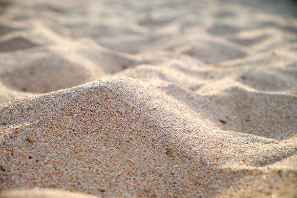 Close up of clean yellow sand surface covering seaside beach illuminated with day light. Travel and vacations concept. - Fotografie, Obrázek