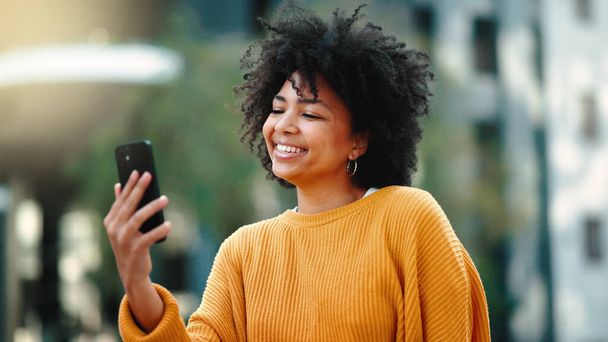 Travel, selfie and black woman in a city, happy and smile on vacation against urban background. Blog, social media and girl influencer live streaming trip in New York for online, followers or network. - Fotoğraf, Görsel