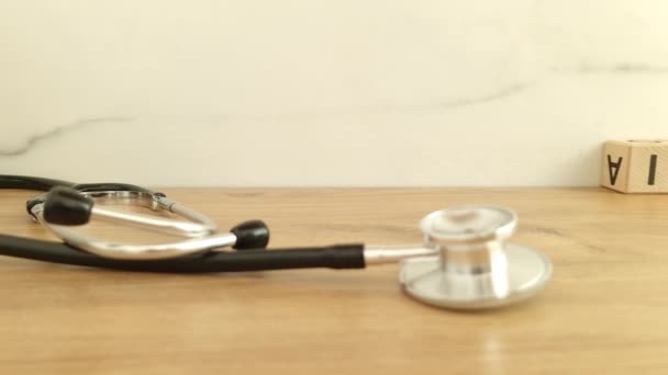 Versicherungswort aus Holzklötzen mit Stethoskop, Hintergrund Gesundheitskonzept - Filmmaterial, Video