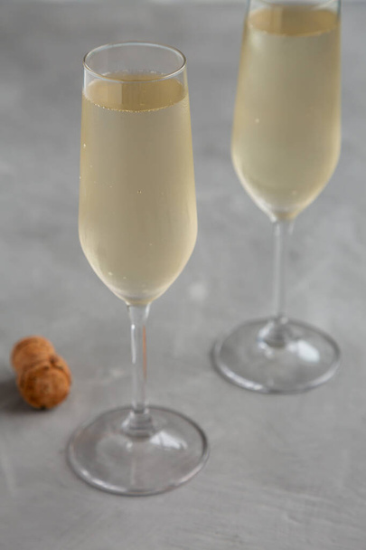 Cold Bubbly Champagne in a Glass on a gray background, side view.  - Photo, Image