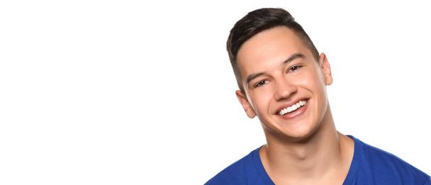 Handsome smiling young man with healthy teeth on white background with space for text - Фото, зображення