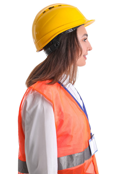 Female worker in vest and hardhat on white background - Foto, afbeelding