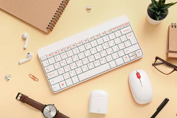 Composition with glasses, keyboard, wristwatch and stationery on beige background - Foto, immagini