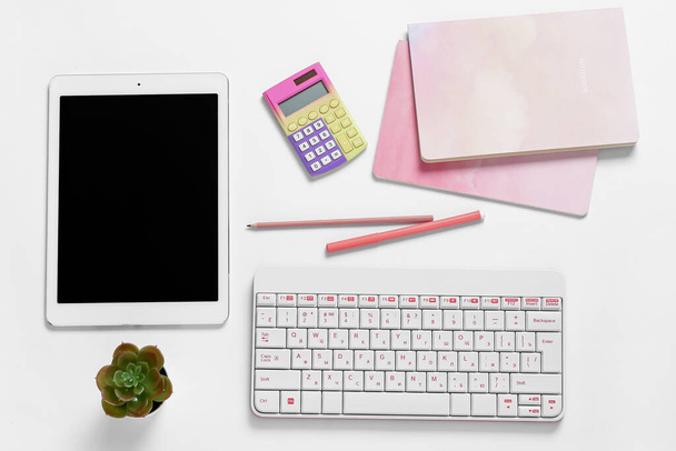 Composition with tablet computer, keyboard, pens and notebooks on white background - Photo, Image